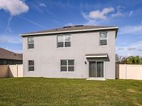 Exterior view of a home for rent. Beautifully landscaped, fenced in backyard, at a home for rent in Apopka, Florida.