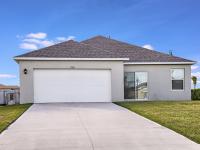 Exterior view with attached garage at a home for rent in Apopka, Florida.