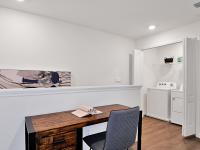 Detail of the interior of our townhomes in Apopka, FL, featuring a desk with a book and in unit laundry closet.