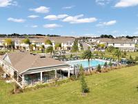 Community pool with beautiful landscaping.