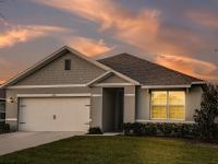 Photograph of the exterior of one of our 1 story townhomes in Apopka, FL, featuring a driveway and garage.
