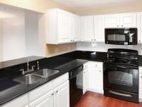 Modern Kitchen with white cabinetry and black appliances and countertops  | Wabash Landing | Apartments in West Lafayette