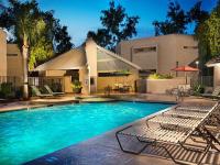 lit pool with lounge chairs at silver creek at night