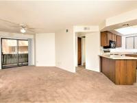 living room with brown carpet and kitchen with peninsula and brown cabinets at Silver Creek
