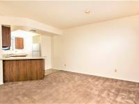 dining area and kitchen with brown carpet at silver creek apartments