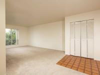 living room with beige carpet and sliding doors to balcony at Bridge Lane