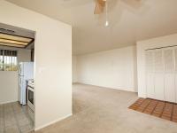 partial view of kitchen and living room with brown carpet at Bridge Lane