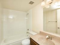 full bath with shower tub combo and beige vanity at Bridge Lane
