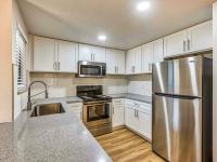 kitchen with granite countertops and stainless steel appliances and at redfield ridge apartments
