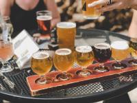 flight of beers and people drinking in the back