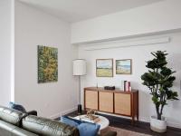 living room with leather sofa and vinyl wood like flooring at oro apartments