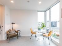 dining area with round table and two yellow chairs at artisan