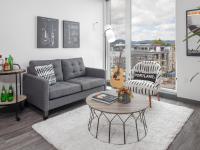 living room with grey sofa and round coffee table with vinyl wood like flooring at parallax apts