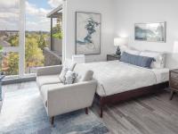 bedroom with bed and side tables and sofa at the foot of the bed at parallax apartments