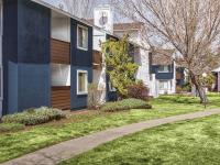 cement pathway in between grass and in front of a 2 story apartment building at redfield ridge