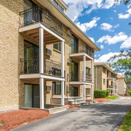 Exterior shot of building featuring balconies  at Princeton Park apartments in Lowell, MA.