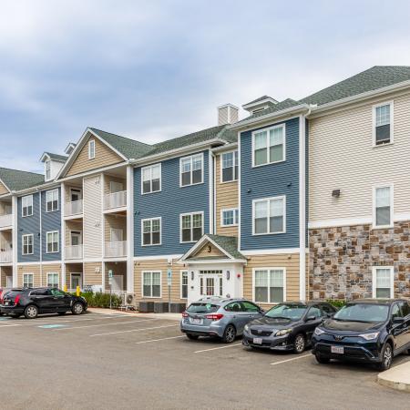 Beautiful Exterior of Mill And 3 with plenty of parking | Apartments For Rent In Chelmsford MA