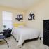 Bedroom with bed, dresser, and desk.