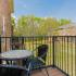 Balcony with small table and two chairs.