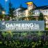 The Gathering monument sign surrounded by green landscaping and buildings in the background.