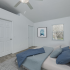 Master bedroom with ceiling fan, window, furniture.