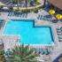 Lexington Crossing aerial view swimming pool with chairs and umbrellas