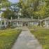 Exterior of the 1 story Chapman Building. There is a sidewalk that leads up to each entrance surrounded by green grass.