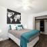 Bedroom with night stand and open closet