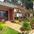 Vineyard Place: Red Brick Exterior, Large Entrance Door, Golden Brick Walkways, Beautiful Landscape.