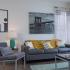 Block75 Apartments, interior, living room, grays and blues, wood floor, area rug, white and blue curtains, large windows, natural light, wall art
