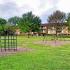 Belmont Park Apts; Exterior, playground, trees, 3 story apt building