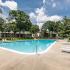 Americana Southdale Apts; Exterior, Olympic size pool, surrounding trees, gated, lounge chairs, life guard