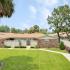 Beach Villas Apartments, exterior, palm trees, large grassy area, walk ways, single story brick buildings, privacy fences,