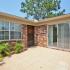 Beach Villas Apartments, exterior, brick building, patio, window, front door, sliding glass door, plants, tree