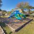 Creekside Park Apartments, exterior, play ground equipment, blue and green, trees, grass, buildings,