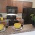 Creekside Park Apartments, interior, kitchen, pass through opening, wood cabinets, black appliances, microwave, stove/oven, refrigerator,