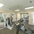Creekside Park Apartments, interior, fitness center, glass door, windows, mirrors, weight machine, elliptical, bikes