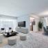 Fallstaff Manor Apts, interior, living room, dining room, plush wall to wall carpet, walkout patio, sofa, two chairs, 2 ottomans, large coffee table, TV console, round dining table, 4 chairs