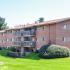 Clarke Manor Apts, Exterior, backside of building, 3 story, patios and balconies, pet station, large landscaped area, brushed, shrubs and trees