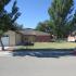A red and grey house with trees growing out of the front lawn. | Military-Friendly Rental Houses Alamogordo, NM