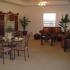 A spacious living room with brown couches and other furnitue. | Alamogordo, NM