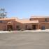 Stucco duplex with cars in driveways
