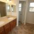 A brightly lit bathroom with two sinks and light cabinets. | Peterson AFB Housing, Colorado Springs, CO