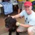 Man kneeling with dog | Island Palm Communities | Rental Homes in Mililani