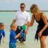 Man and Woman with 2 children playing at the beach | Hickam Communities | Hickam Communities