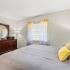 The Loop at Wedgewood model unit master bedroom: staged furniture, bed, carpeted flooring