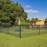 The Lodge at Woodlake apartments, exterior, gated dog park, picnic tables, apartment exterior