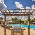 The Lodge at Woodlake apartments, exterior, barbecue grill, sparkling blue pool, lounge chairs, brick walkways, building exteriors