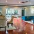 Calibre Bend Apartments clubhouse interior: sofas and coffee table, glass table and chairs, pool table.