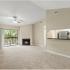 Beneva Place Apartments, interior, living room, carpeted, fireplace, sliding glass door to balcony, high ceilings, ceiling, breakfast bar to kitchen, stainless steel fridge, white cabinets